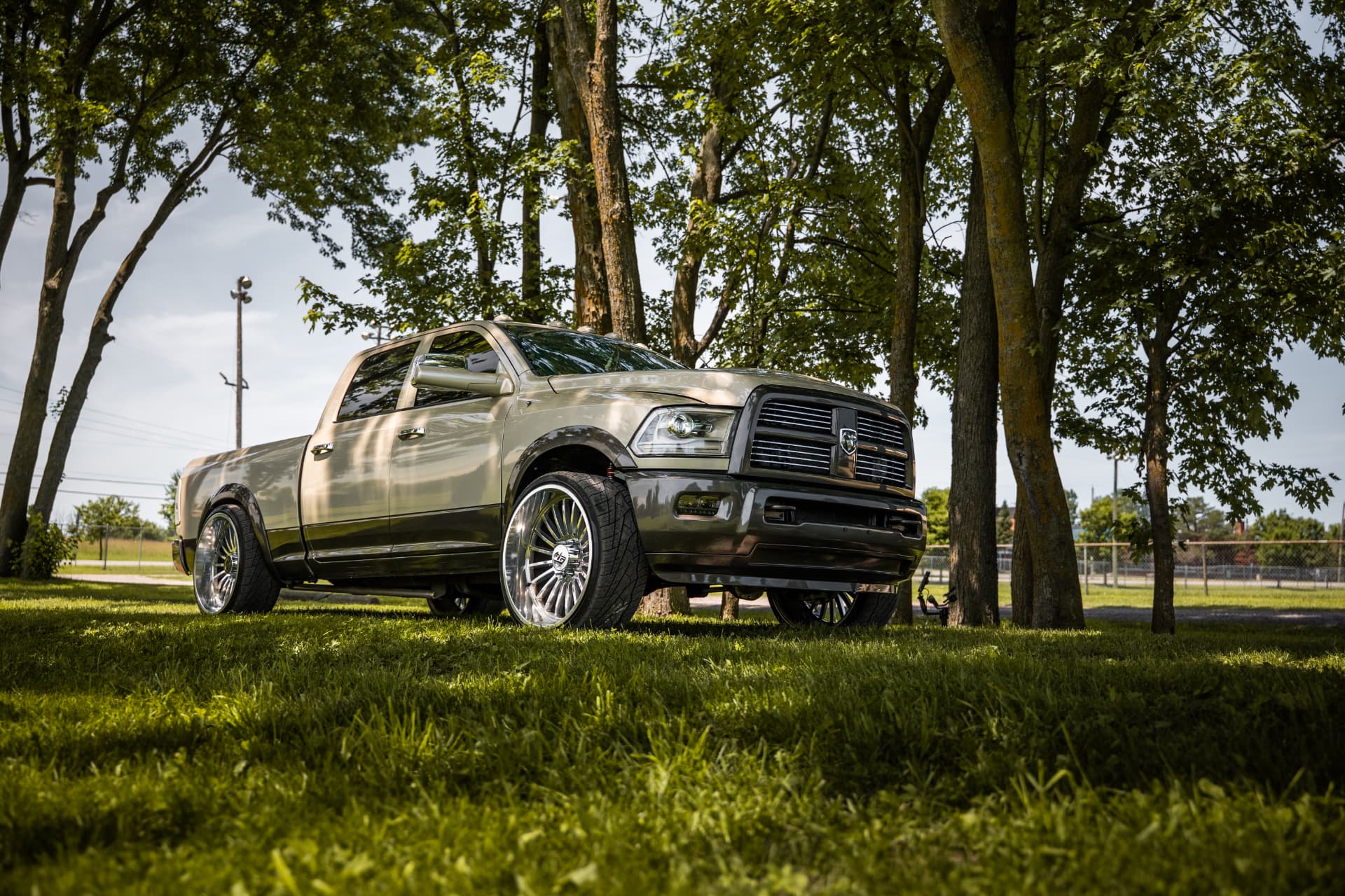 Custom olive-gold Ram dually on polished wheels built at Foggy Customs